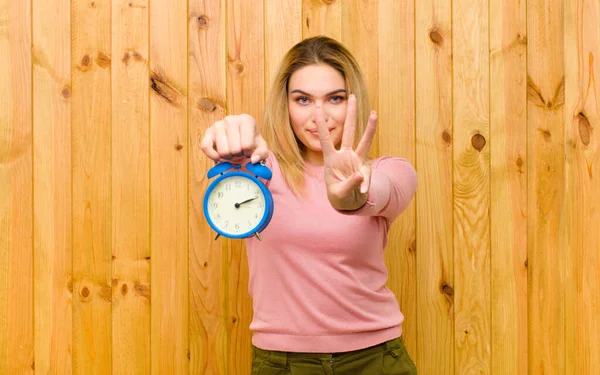 Young Pretty Blonde Woman Alarm Clock Wood Wall — Stock Photo, Image