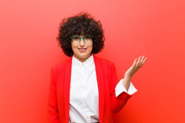 Genç, güzel afro kadın mutlu, şaşkın ve neşeli, pozitif bir tavırla gülümseyen, bir çözüm ya da fikir gerçekleştiren