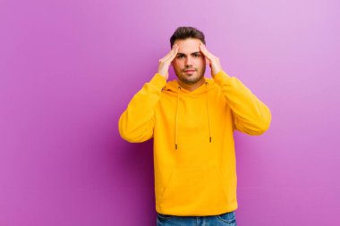 Mor arka planda sıradan görünüşlü genç bir İspanyol.