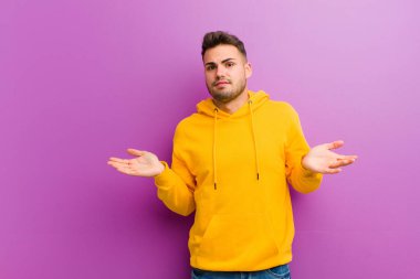 Mor arka planda sıradan görünüşlü genç bir İspanyol.
