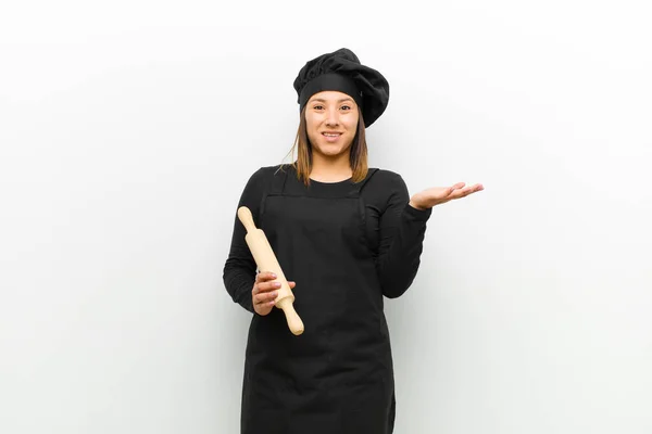 cook woman feeling happy, surprised and cheerful, smiling with positive attitude, realizing a solution or idea against white background