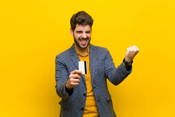 Jovem homem bonito contra fundo laranja — Fotografia de Stock