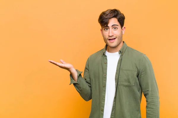 Young Handsome Man Looking Surprised Shocked Jaw Dropped Holding Object — Stock Photo, Image