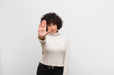 Genç, güzel afro kadın ciddi, sert, hoşnutsuz ve kızgın görünüyor.