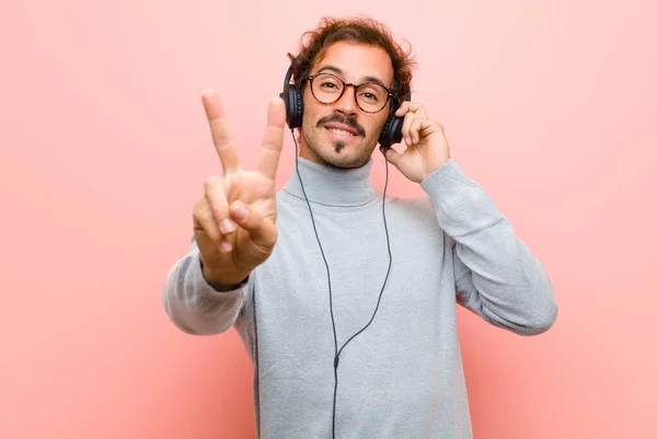 Young Handsome Man Headphones Pink Flat Wall — Stockfoto