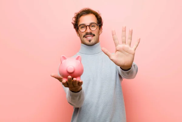 Young Handsome Man Piggy Bank Pink Flat Wall — Stock Photo, Image