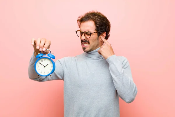 Young Handsome Man Alarm Clock Pink Flat Wall — Stock Photo, Image