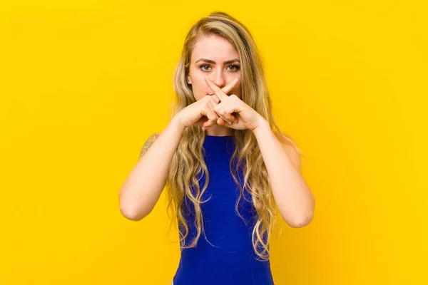 Young Blonde Woman Looking Serious Displeased Both Fingers Crossed Front — Stock Photo, Image