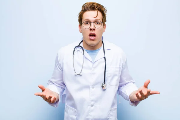 Young Red Head Doctor Feeling Extremely Shocked Surprised Anxious Panicking — Stock Photo, Image