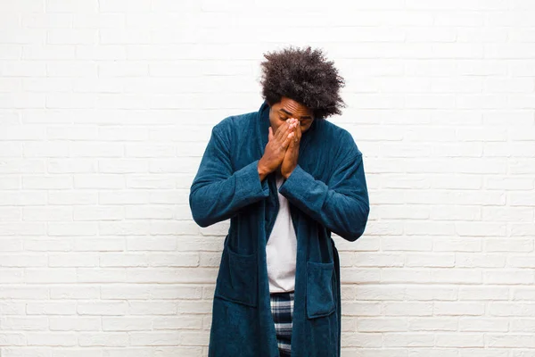 Young Black Man Wearing Pajamas Gown Feeling Worried Hopeful Religious — Stock Photo, Image