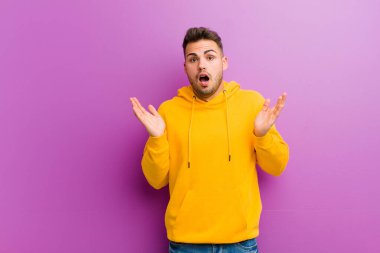 Mor arka planda sıradan görünüşlü genç bir İspanyol.