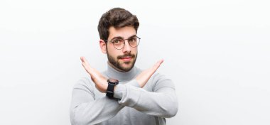 Genç müdür senin bu tavrından rahatsız ve sıkılmış görünüyor. Yeter artık! Eller önde çapraz, beyaz duvara karşı durmanı söylüyor.