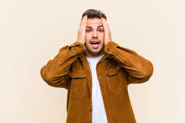 Young Hispanic Man Raising Hands Head Open Mouthed Feeling Extremely — ストック写真