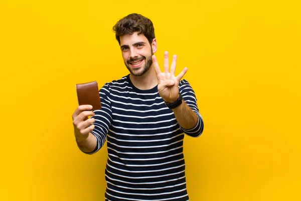 Jovem homem bonito contra fundo laranja — Fotografia de Stock