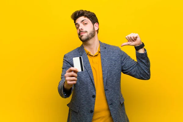 Young handsome man against orange background — Stock Photo, Image