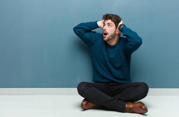 Young Handsome Man Sitting Floor Open Mouth Looking Horrified Shocked — Stock Photo, Image