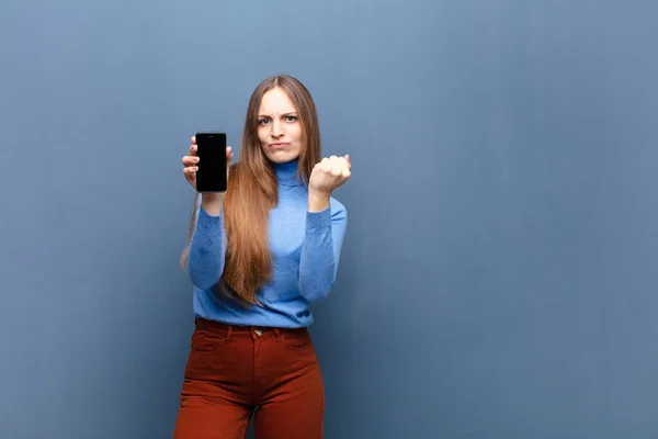Young Pretty Woman Using Smart Phone Blue Wall Copy Space — Zdjęcie stockowe