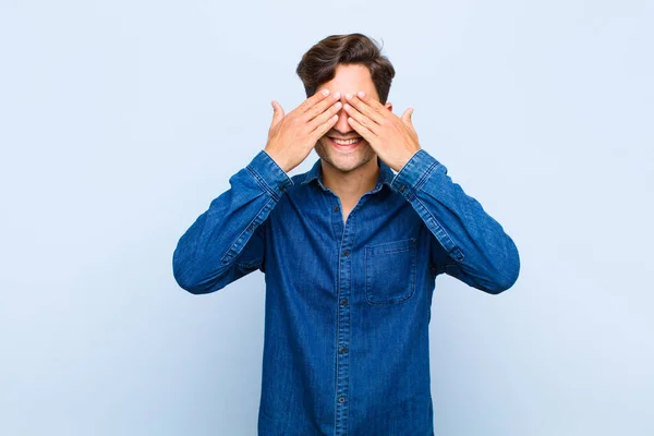 Jovem Bonito Homem Sorrindo Sentindo Feliz Cobrindo Olhos Com Duas — Fotografia de Stock