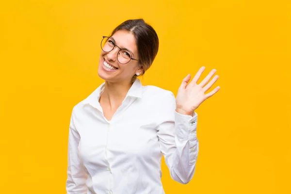 Young Businesswoman Smiling Happily Cheerfully Waving Hand Welcoming Greeting You — ストック写真