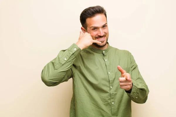 Young Handsome Man Smiling Cheerfully Pointing Camera While Making Call — Stock Photo, Image
