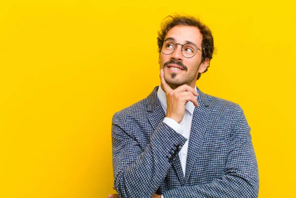 Young Handsome Man Smiling Happily Daydreaming Doubting Looking Side Orange — Stock Photo, Image