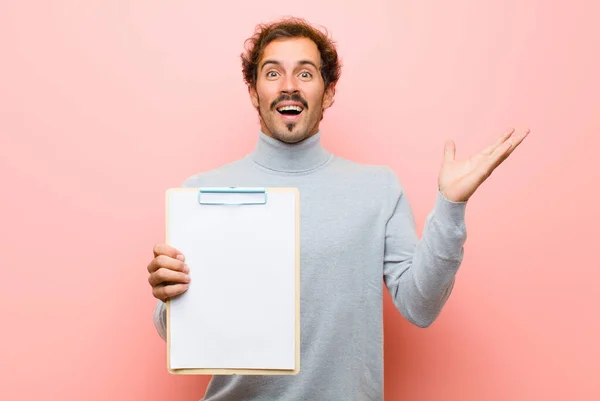 Joven Hombre Guapo Con Una Hoja Papel Contra Pared Plana —  Fotos de Stock