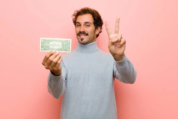 Joven Hombre Guapo Con Billetes Dólar Contra Pared Plana Rosa — Foto de Stock