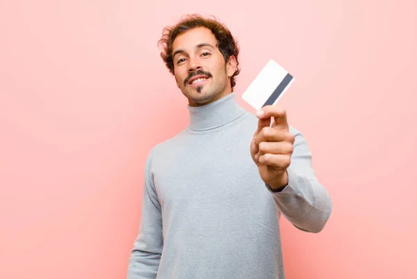 Young Handsome Man Credit Card Pink Flat Wall — Stock Photo, Image