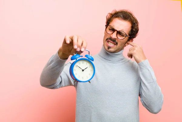 Joven Hombre Guapo Con Reloj Despertador Contra Pared Plana Rosa — Foto de Stock