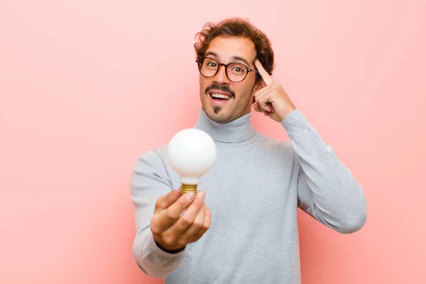 Young Handsome Man Having Idea Light Bulb Pink Flat Wall — Stock Photo, Image