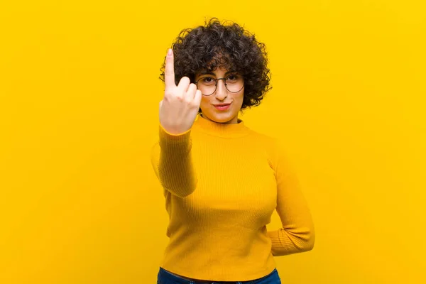 stock image young pretty afro woman smiling and looking friendly, showing number one or first with hand forward, counting down