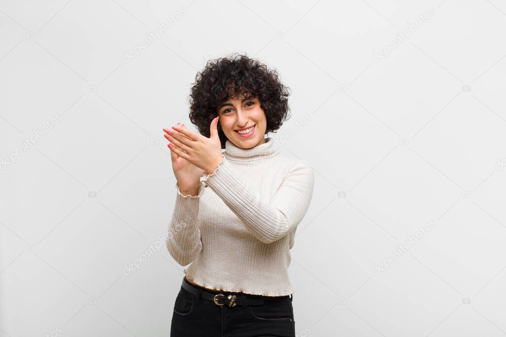 young pretty afro woman feeling happy and successful, smiling and clapping hands, saying congratulations with an applause
