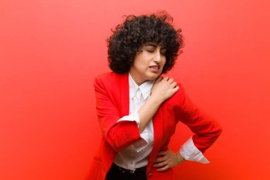 Genç, güzel afro kadın yorgun, stresli, endişeli, hayal kırıklığına uğramış ve depresyonda, sırtı ya da boynu ağrıyan