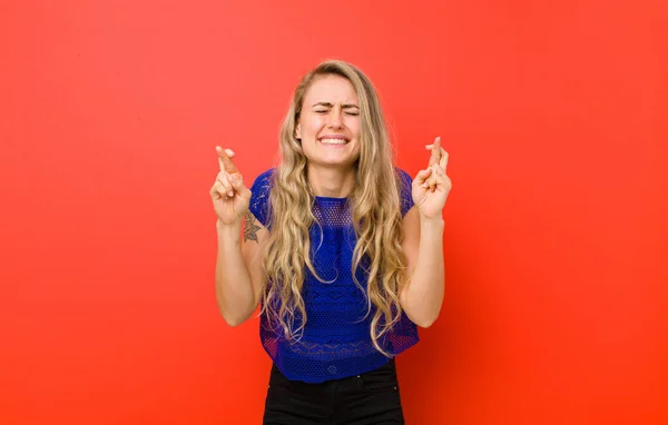 Young Blonde Woman Smiling Anxiously Crossing Both Fingers Feeling Worried — Stock Photo, Image