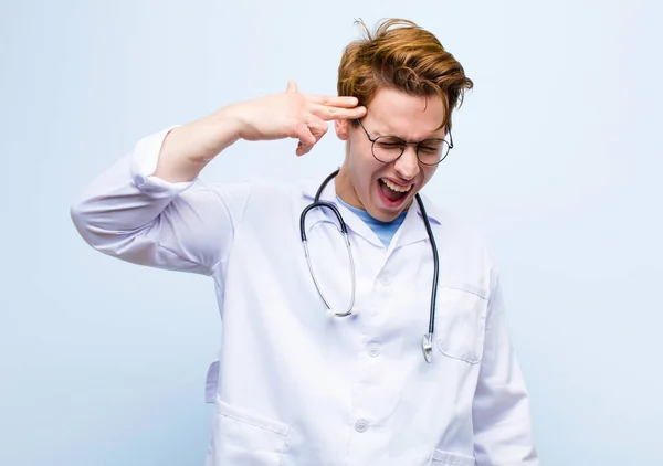Young Red Head Doctor Looking Unhappy Stressed Suicide Gesture Making — Stockfoto