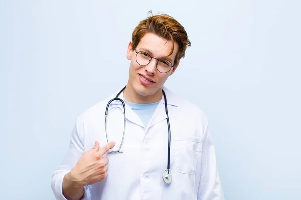 Young Red Head Doctor Looking Proud Confident Happy Smiling Pointing — Stockfoto