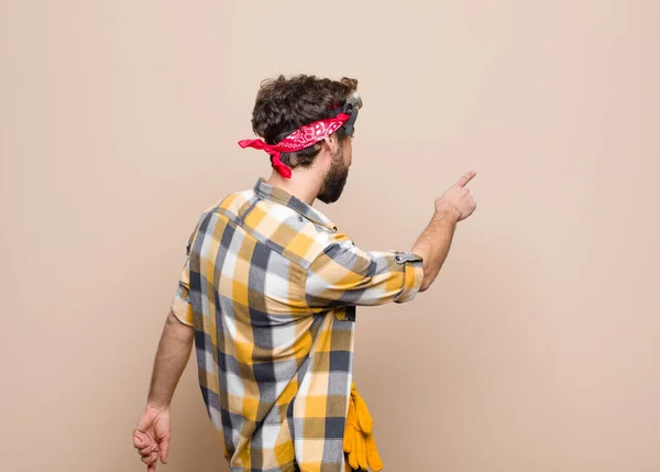 Young Housekeeper Man Standing Pointing Object Copy Space Rear View — Stock Photo, Image