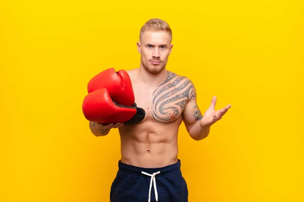Young Blonde Strong Man Feeling Puzzled Confused Doubting Weighting Choosing — Stock Photo, Image