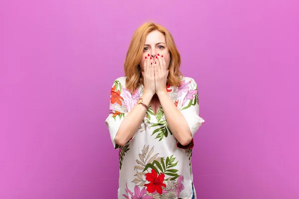 middle age woman feeling worried, upset and scared, covering mouth with hands, looking anxious and having messed up