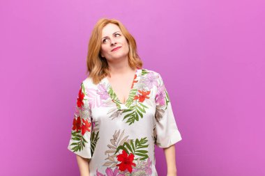 Orta yaşlı kadın merak ediyor, mutlu düşünceler ve fikirler düşünüyor, hayal kuruyor, kenarda yer arıyor.