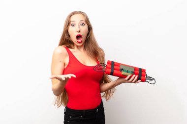 Genç sarışın kadın şok olmuş, şaşırmış, endişeli ve paniklemiş hissediyor. Stresli ve dehşete düşmüş bir şekilde elinde bir bomba tutuyor.