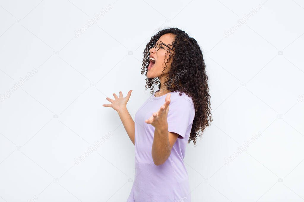 young black woman performing opera or singing at a concert or show, feeling romantic, artistic and passionate against white wall