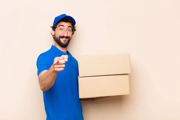 young bearded delivery man with a box