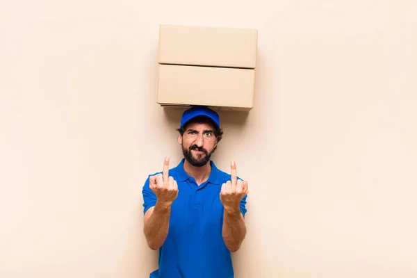 young bearded delivery man with a box