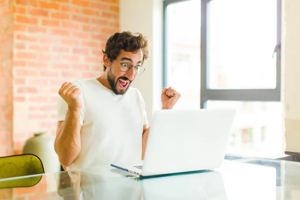 Young Bearded Man Laptop Feeling Shocked Excited Happy Laughing Celebrating — Stock Photo, Image