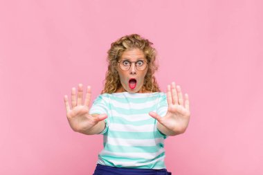 Orta yaşlı bir kadın sersemlemiş ve korkmuş hissediyor. Korkutucu bir şeyden korkuyor. Elleri açık ve uzak durun diyor.