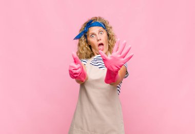 Orta yaşlı bir kadın gülümsüyor ve arkadaş canlısı görünüyor. Altıncı ya da altıncı numarayı gösteriyor. Elleri önde, kahya konseptini sayıyor.