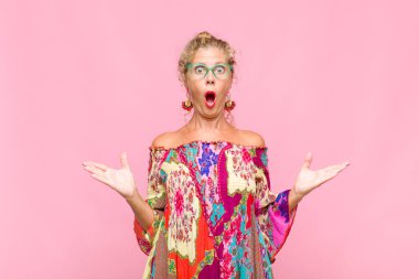 Orta yaşlı bir kadın inanılmaz bir sürprizle şaşkın ve şaşkın.