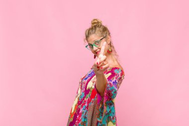 Orta yaşlı bir kadın gülümsüyor ve arkadaş canlısı görünüyor. Bir numara ya da ilk eli önde, geriye doğru sayıyor.