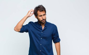 Şaşırmış, gergin, endişeli ya da korkmuş bakışları olan genç Latin yakışıklı bir adam.